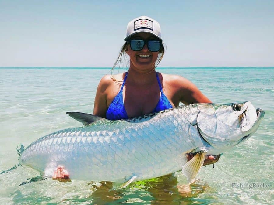 girl holding a tarpon