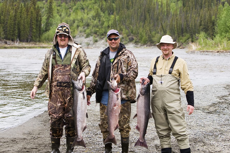 men with freshly caught salmon