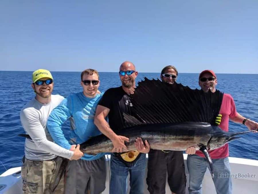 group holding a sailfish