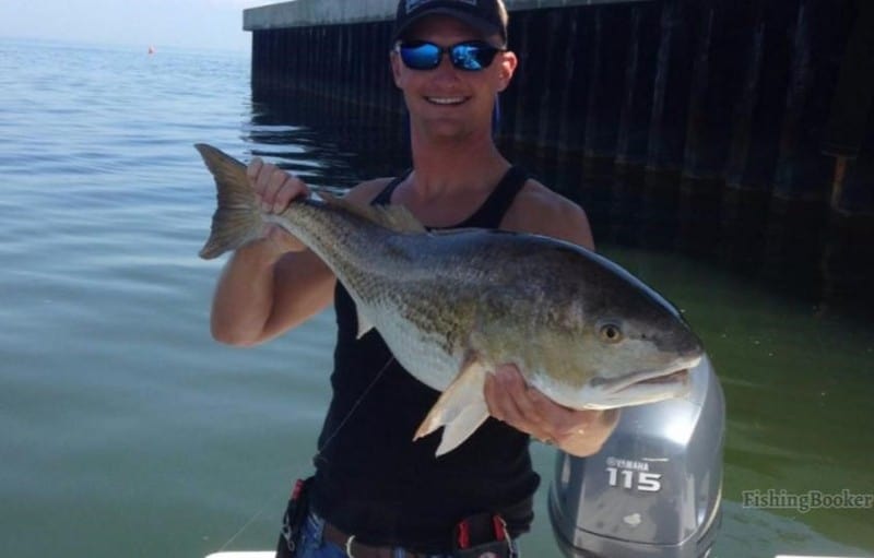 redfish caught by happy angler